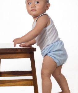 baby walking along furniture